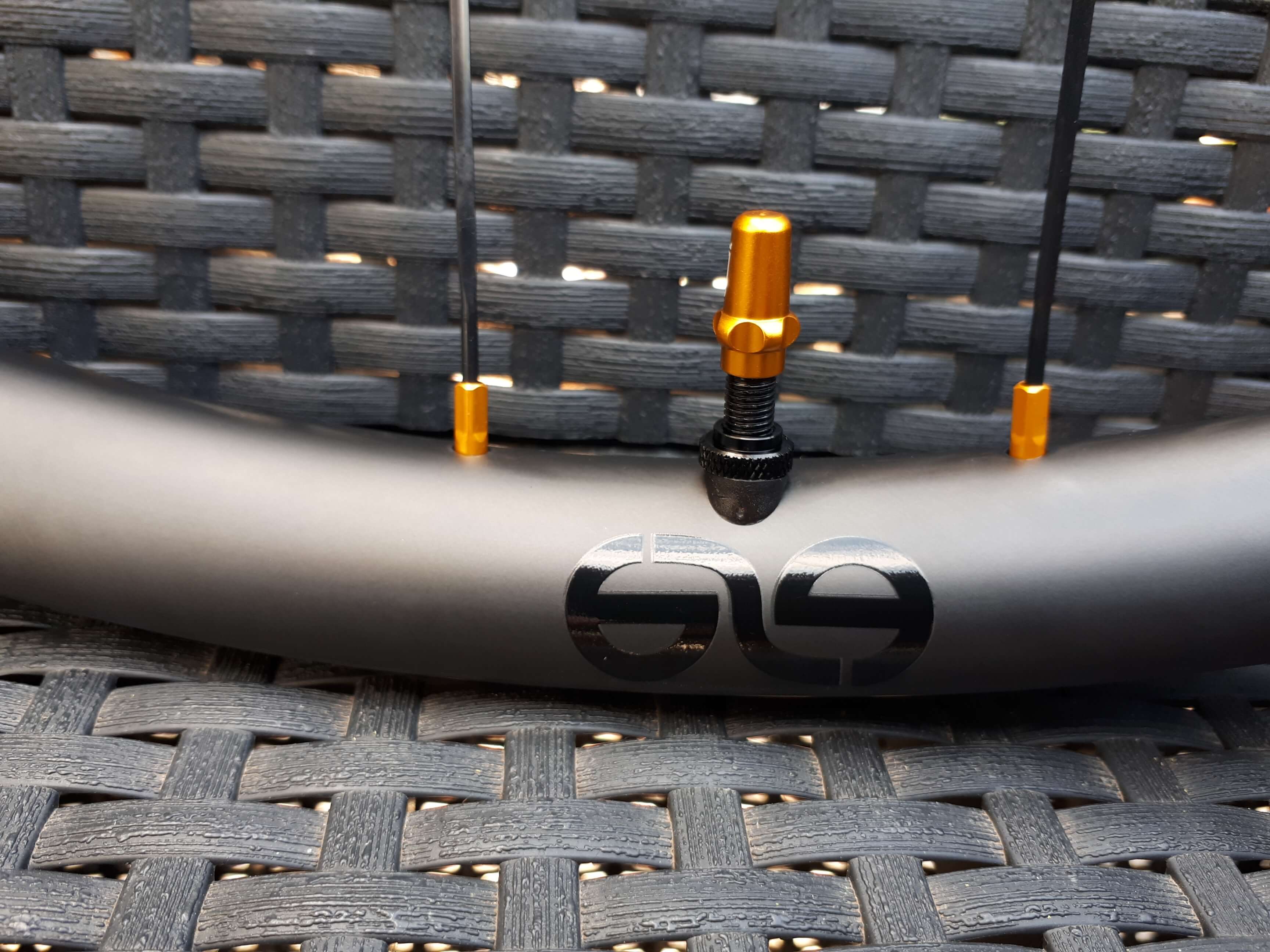 eie carbon mtb bike rims with glossy black decals on valve hole